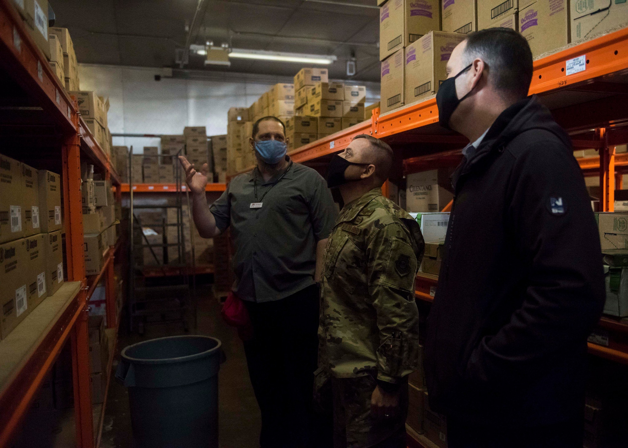 A commissary worker points something out to a military member