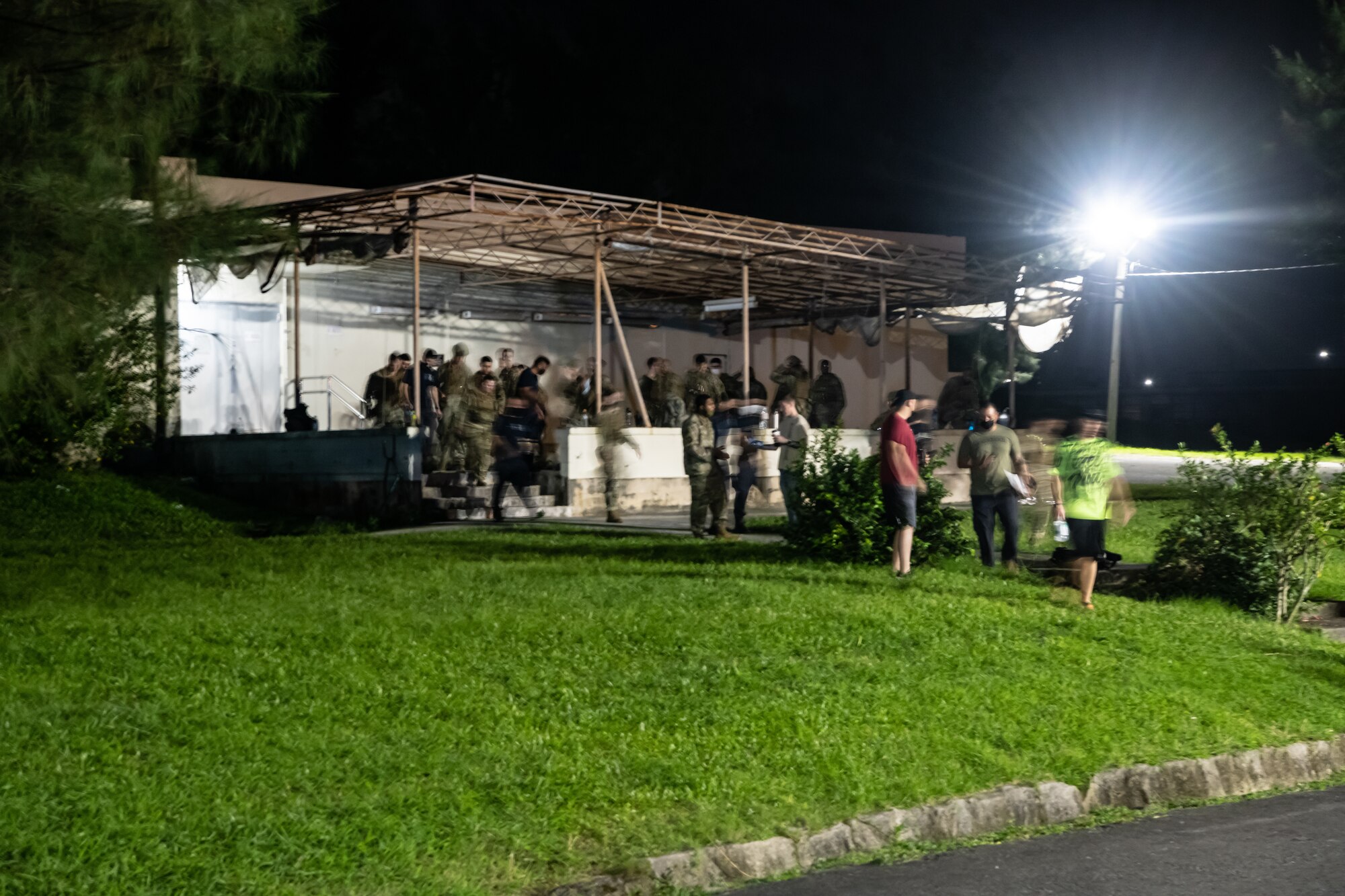 Defenders from the 18th Security Forces Squadron disperse after the initial briefing for the Defender Flight of the Quarter Challenge on Kadena Air Base, Japan, Aug. 12, 2021. The challenge consisted of four main stations where participants were tested on field stripping weapons in low-light conditions, providing medical care under fire, room clearing, and conducting a high-risk traffic stop. (U.S. Air Force photo by Tech. Sgt. Micaiah Anthony)