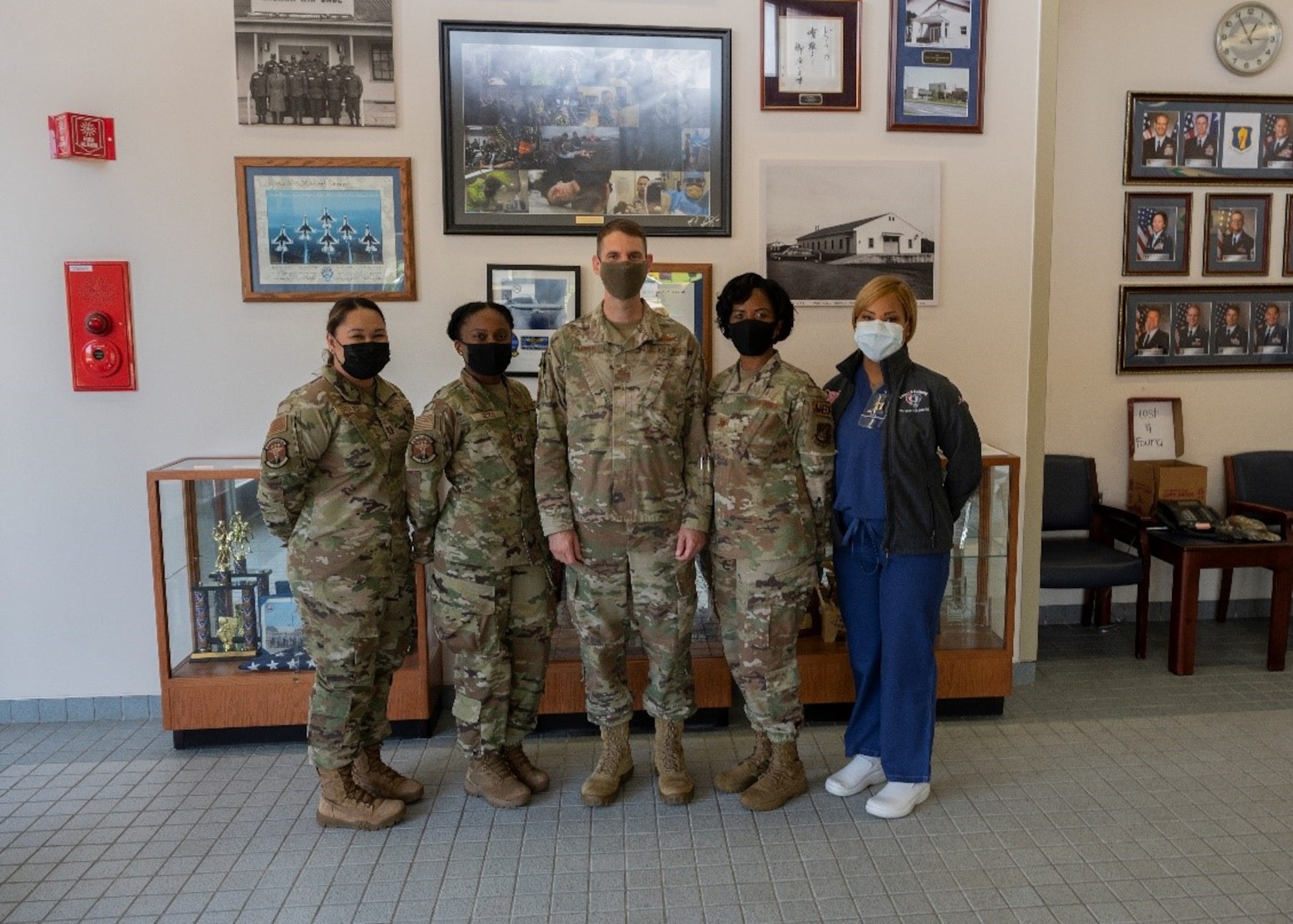 Five Airmen pose for a group photo in brown uniform.