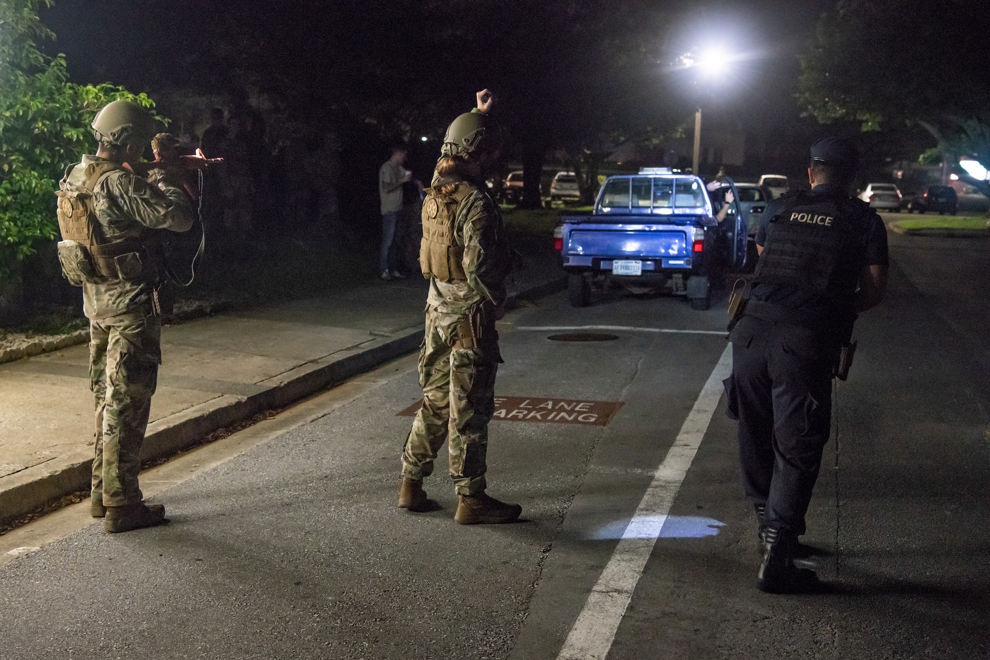 Defenders from the 18th Security Forces Squadron conduct a simulated high-risk traffic stop during the Defender Flight of the Quarter Challenge on Kadena Air Base, Japan, Aug. 12, 2021. The simulated high-risk traffic stop consisted of ordering all occupants out of the vehicle, placing the individuals in custody, and searching the vehicle. (U.S. Air Force photo by Tech. Sgt. Micaiah Anthony)