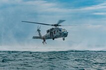 GAETA, Italy (July 19, 2021) A search and rescue swimmer jumps out of an MH-60 Sea Hawk helicopter attached to the “Dragon Whales” of Helicopter Sea Combat Squadron (HSC) 28 during training with the Blue Ridge-class Command and control ship USS Mount Whitney (LCC 20) off the coast of Gaeta, Italy, July 19, 2021.