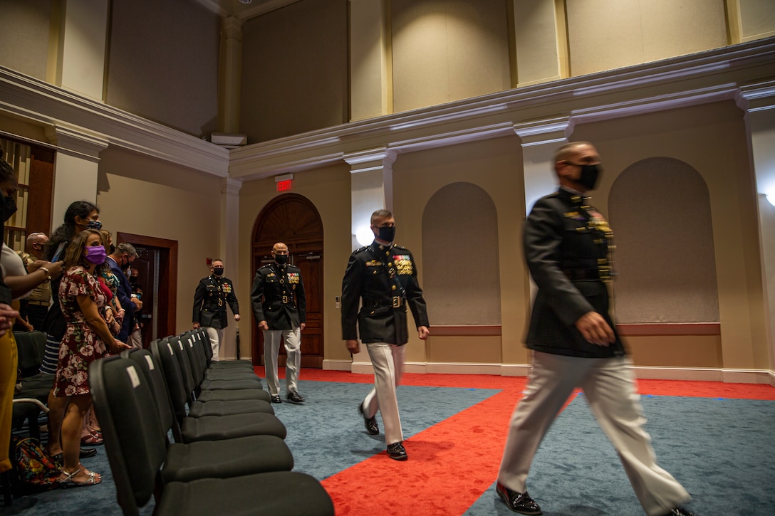 Honorees walk to their seats during the Brigadier General Select Orientation Course Honors Ceremony at Marine Barracks Washington, Aug. 16, 2021. The ceremony honors newly promoted and soon-to-be promoted brigadier generals along with senior executives. BGSOC is an annual, week-long course held in the National Capital Region to instruct the newly promoted individuals on their new rank and responsibilities. The hosting official for the evening was 38th Commandant of the Marine Corps, Gen. David H. Berger. (U.S. Marine Corps photo by Lance Cpl. Tanner D. Lambert)