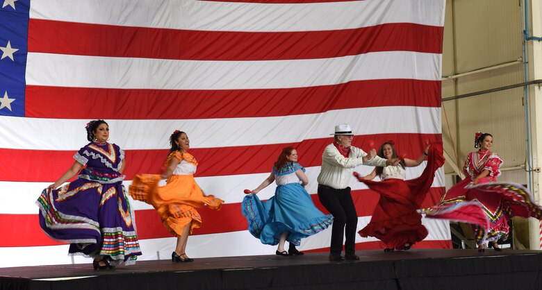 Team Mildenhall spouses perform during the Diversity and Inclusion Day at Royal Air Force Mildenhall, England, Aug. 13, 2021. The event included a variety of performances, food and informational booths, a fire truck, Humvee and various static aircraft. (U.S. Air Force photo by Karen Abeyasekere)