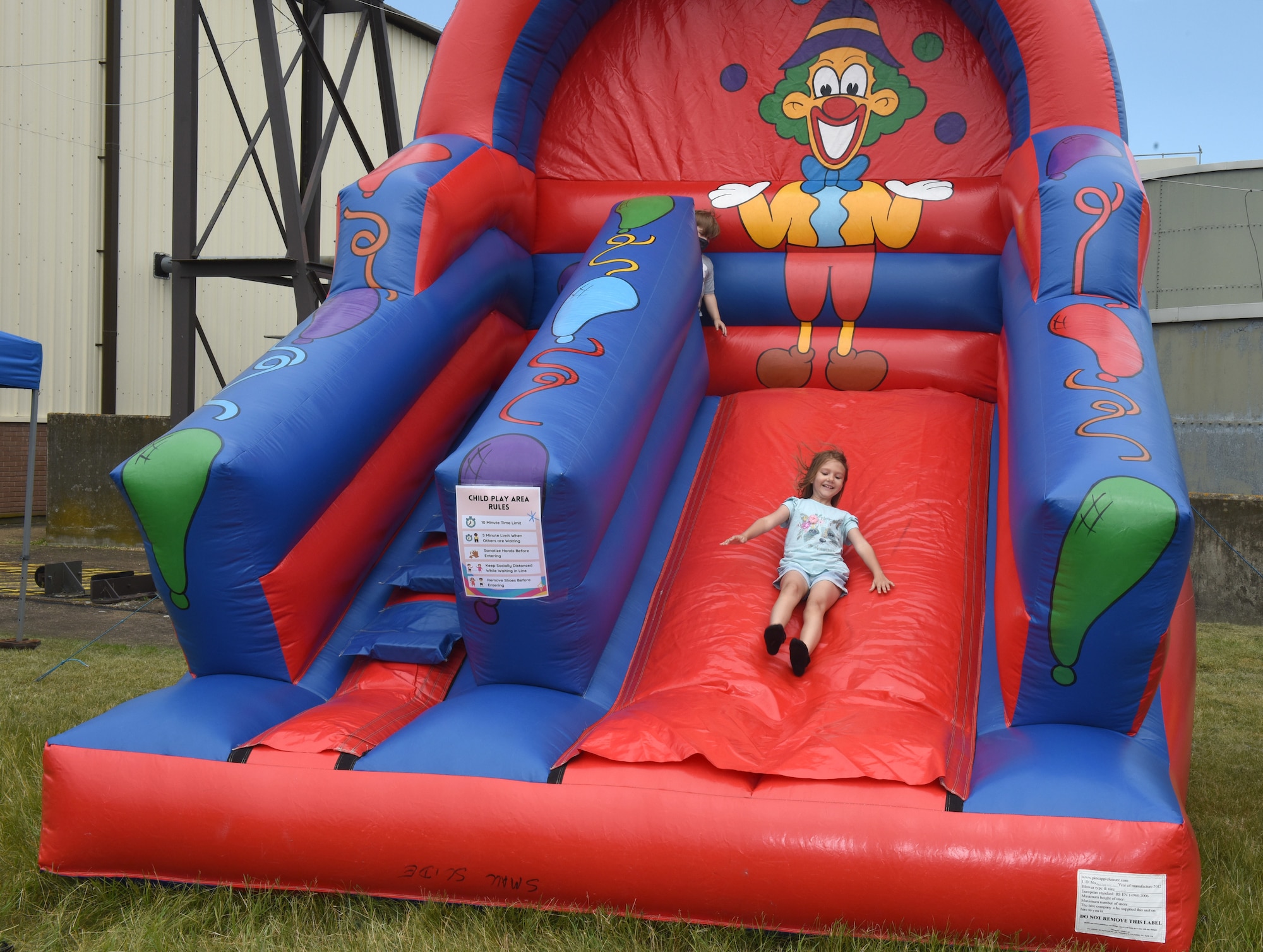 A Team Mildenhall child plays on a bouncy castle during the Diversity and Inclusion Day event at Royal Air Force Mildenhall, England, Aug. 13, 2021. The event included a variety of performances, food and informational booths, a fire truck, Humvee and various static aircraft. (U.S. Air Force photo by Karen Abeyasekere)