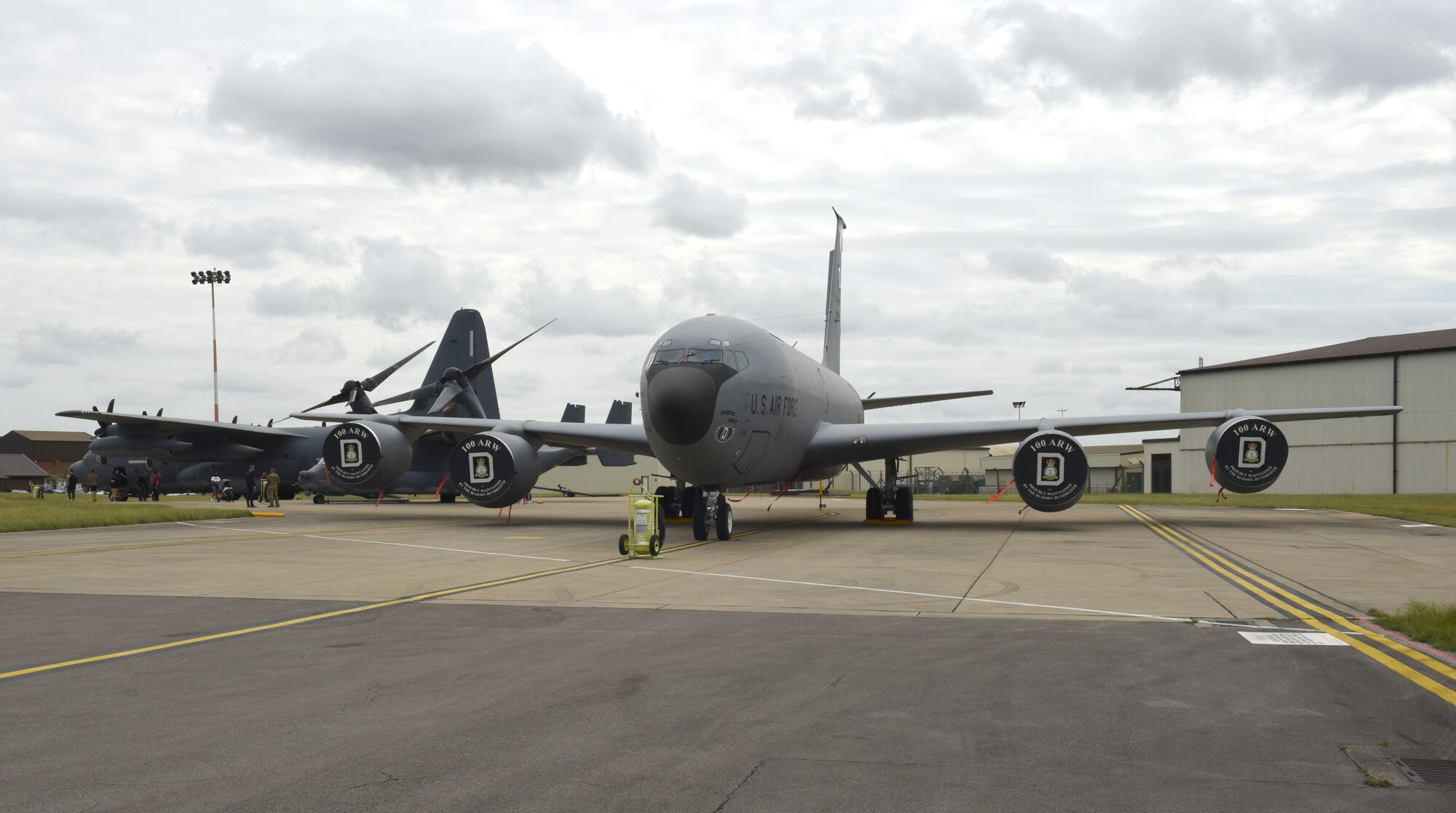 A U.S. Air Force MC-130J Commando II, CV-22 Osprey and KC-135 Stratotanker sit on the flightline during Diversity and Inclusion Day at Royal Air Force Mildenhall, England, Aug. 13, 2021. The event included a variety of performances, food and informational booths, a fire truck and Humvee. (U.S. Air Force photo by Karen Abeyasekere)