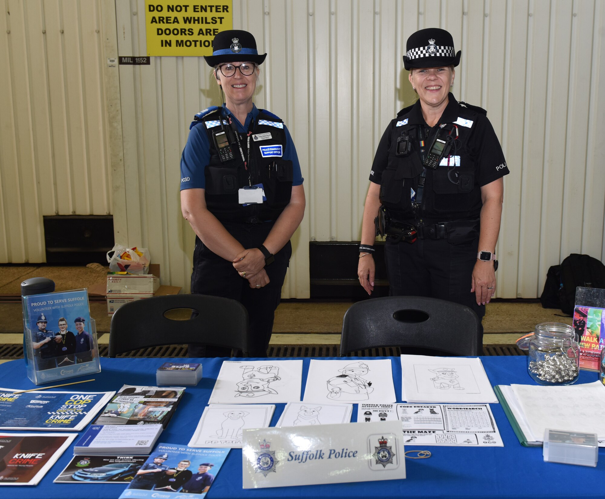 Suffolk Police pose for a photo at their booth at the Diversity and Inclusion Day event at Royal Air Force Mildenhall, England, Aug. 13, 2021. The event included a variety of performances, food and informational booths, bouncy castles, a fire truck, Humvee and various static aircraft. (U.S. Air Force photo by Karen Abeyasekere)