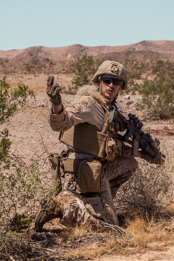 Cpl. Wyatt Witter, a scout team leader with Delta Company, 4th Light Armored Reconnaissance Battalion (LAR), 4th Marine Division, commands his Marines to push forward while conducting a platoon attack during Integrated Training Exercise (ITX) 4-21 at Marine Corps Air Ground Combat Center, Twentynine Palms, California on Aug. 2, 2021. ITX is the culmination of Marine Forces Reserve units’ training cycle as they participate in a live-fire, combined arms exercise as a part of an integrated Marine Air Ground Task Force. (U.S Marine Corps photo by Lance Cpl. David Intriago)