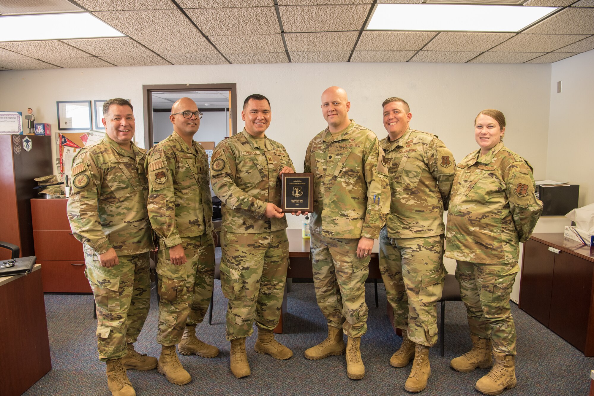 The 162nd Wing Legal Office team poses for a photo with their award for Special Unit Legal Office of the Year Award for 2020