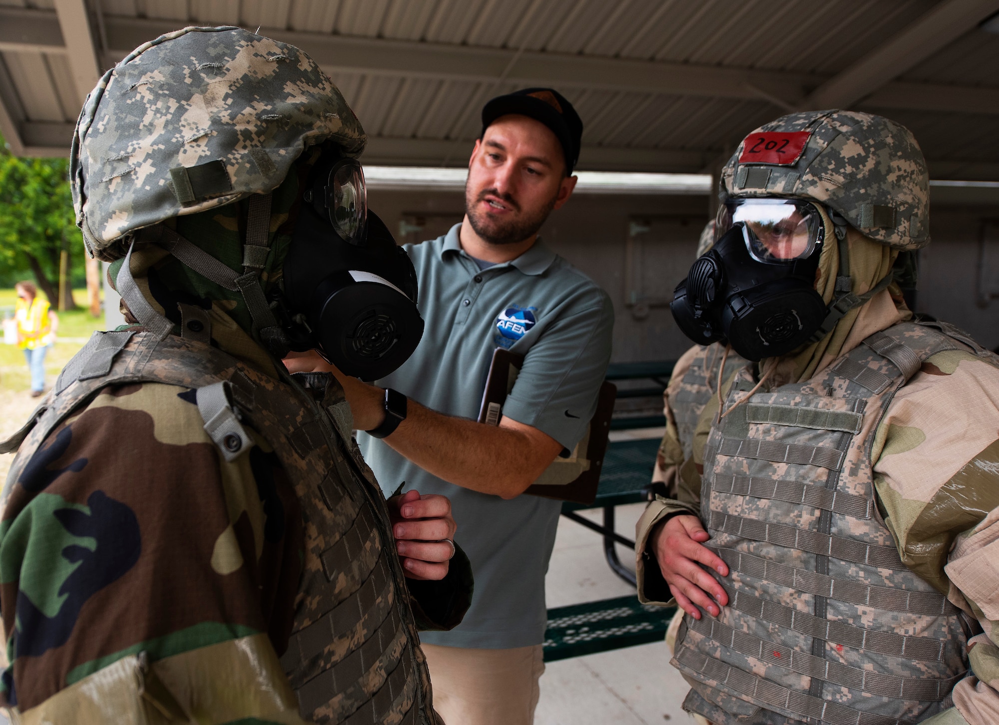 Brandon Ashcraft, 788th Civil Engineering Squadron Emergency Management Branch, checks the M50 gas mask an 88th Air Base Wing Airman during training August 11, 2021, at the Warfighter Training Center at Wright-Patterson Air Force Base, Ohio. Periodic refresher training helps Airmen prepare for emergencies. (U.S. Air Force photo by R.J. Oriez)