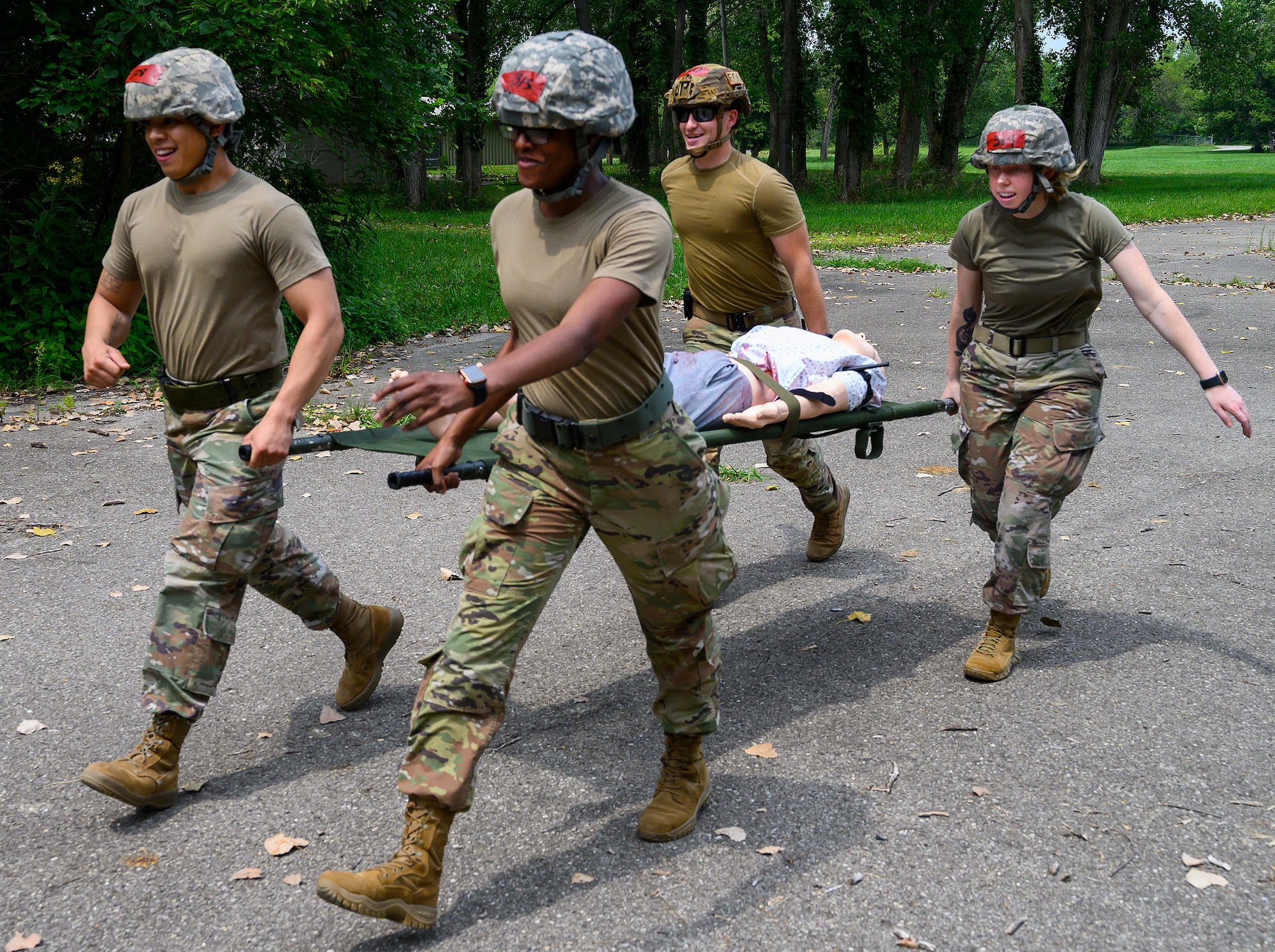 From left, Senior Airman Ivan Tendenilla, 88th Comptroller Squadron; Airman1st Class Andrew Ertmer, 788th Civil Engineering Explosive Ordinance Disposal; 1st Lt Juawana Stringer, 88th Medical Group; and    Kristin Betsch, Senior Airman Kristin Betsch, 88th Medical Group; practice carrying a patient on a litter during buddy care training at the Warfighter Training Center at Wright-Patterson Air Force Base, Ohio. Active duty members of the 88th Air Base Wing, went through refresher training to help them prepare for emergencies. (U.S. Air Force photo by R.J. Oriez)