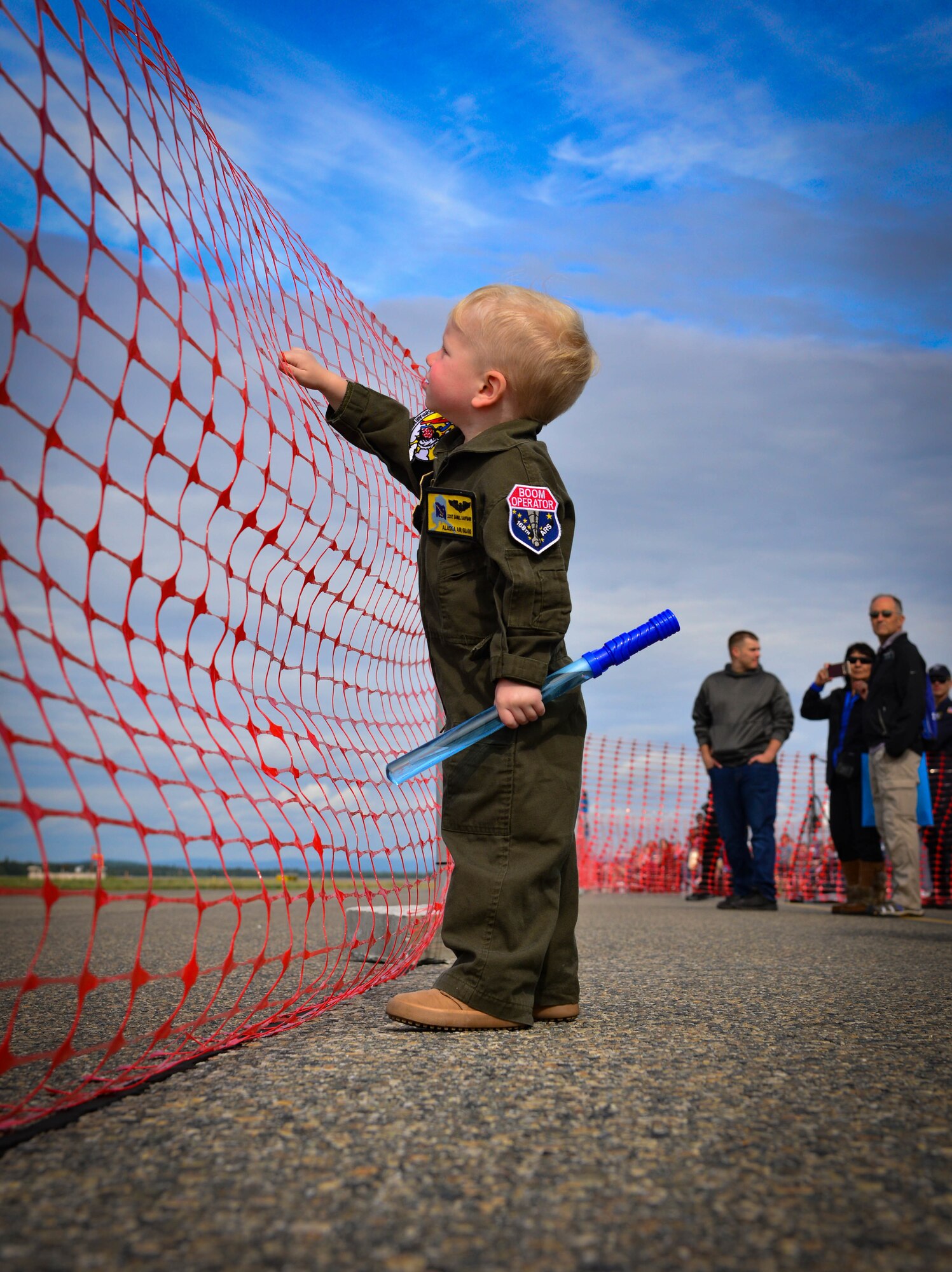 A child watches the 2021 Arctic Lightning Airshow July 29th, 2021, on Eielson Air Force Base, Alaska.