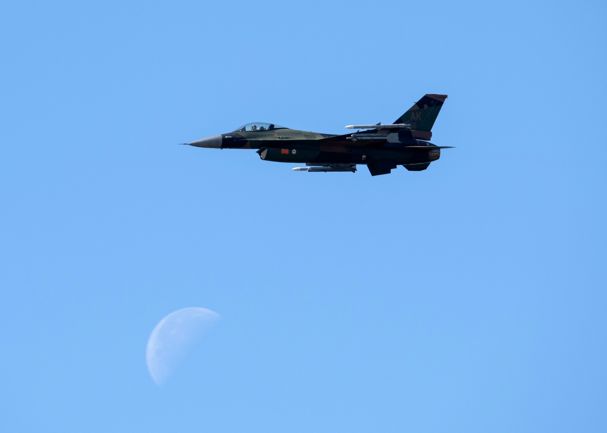 A U.S. Air Force F-16 Fighting Falcon assigned to the 18th Aggressor Squadron flies as part of Arctic Lighting Airshow 2021 at Eielson Air Force Base, Alaska, July 31, 2021.