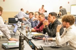 A team discusses strategies during the Wargame for Innovation and Frontline Improvisation Pilot event, hosted by NSWC IHD at the College of Southern Maryland’s Velocity Center in Indian Head, Maryland, July 27.