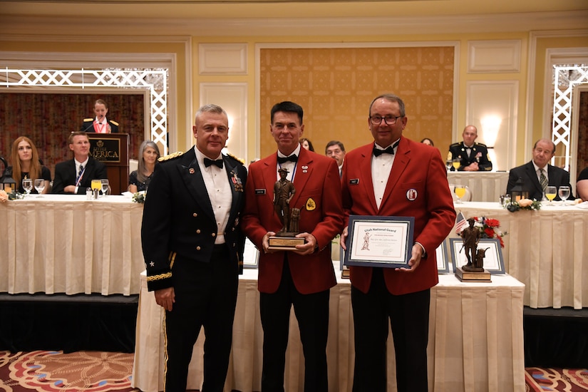 Maj. Gen. (Ret.) Jeff Burton (center), the previous adjutant general of the Utah National Guard, receives the Bronze Minuteman award