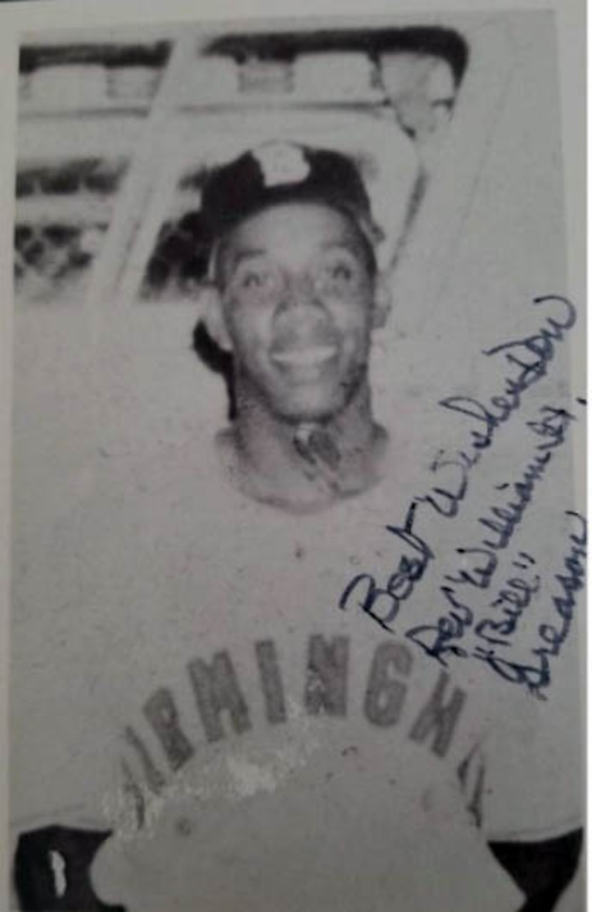 A baseball player poses for a photo.