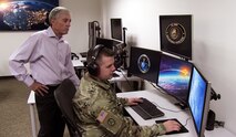 Clem Morris, Missile Defense Training Division chief at the Space and Missile Defense School, trains Sgt. 1st Class Kacee Love on the new Mission Specific Vendor Plug-in Command and Control, Battle Management and Communications Training System, Aug. 2, in Colorado Springs, Colorado. (U.S. Army photo by Daniel Santistevan)