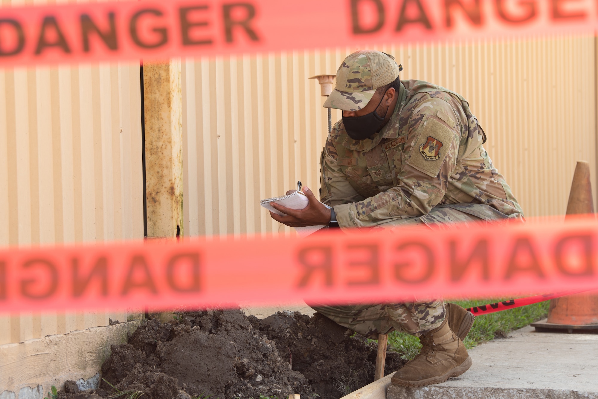 U.S. Air Force Staff Sgt. Kenneth Reid, 375th Air Mobility Wing Safety occupational safety craftsman, writes details about damage on a building on Scott Air Force Base, Illinois, August 12, 2021. Documentation on the integrity of the building is important to prevent hazardous working conditions. (U.S. Air Force photo by Airman 1st Class Stephanie Henry)