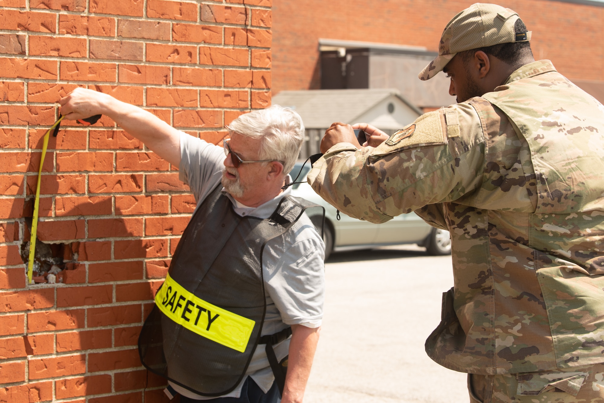 Don Jones, 375th Air Mobility Wing Safety occupational safety and health specialist, and U.S. Air Force Staff Sgt. Kenneth Reid, 375th Air Mobility Wing Safety occupational safety craftsman, documents structural damage on Scott Air Force Base, Illinois, August 12, 2021. Safety inspections are critical to prevent injuries to personnel and damage to military property and equipment. (U.S. Air Force photo by Airman 1st Class Stephanie Henry)