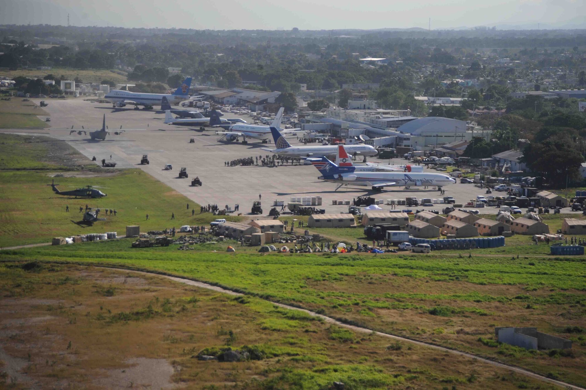 Airplanes wait for off-load to support in earthquake relief efforts at the Port-au-Prince International Airport. Part-au-Prince was hit by a devastating 7.0 magnitude earthquake Jan. 12, 2010.