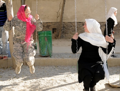 U.S. 1st Lt. Ana Monteiro, 1st Battalion, 101st Field Artillery Regiment (1-101st), Massachusetts Army National Guard, swings with an Afghan girl at Ariana School during a humanitarian aid drop of school supplies on Nov. 10, 2010, in Kabul, Afghanistan. Monteiro and other Soldiers of the 1-101st have 'adopted' the mostly girl school by providing three more classrooms and donating school supplies several times since May.