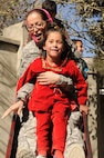 U.S. 1st Lt. Ana Monteiro, 1st Battalion, 101st Field Artillery Regiment (1-101st), Massachusetts Army National Guard, goes down a slide with an Afghan girl at Arian School during a humanitarian aid drop of school supplies on Nov. 10, 2010, in Kabul, Afghanistan. Monteiro and other Soldiers of the 1-101st have 'adopted' the mostly girl school by providing three more classrooms and donating school supplies several times since May