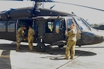 Puerto Rico National Guard Soldiers prepare UH-60 Black Hawk helicopters to deploy to Haiti in support of USAID humanitarian relief efforts on Aug. 17, 2021, to the Army Aviation Support Facility at the Fernando Ribas Dominicci Airport.
