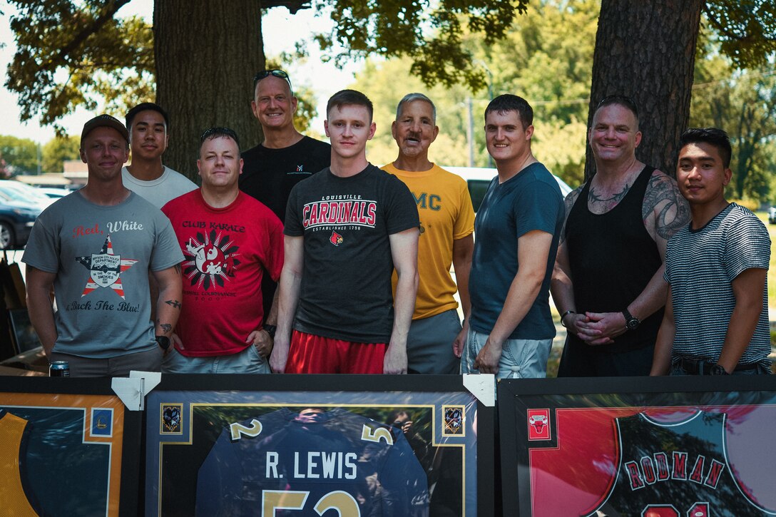 Event coordinators and volunteers pose for a photo during the Military Market and Enlisted Service Celebration at the Community Commons on Joint Base Andrews, Md., Aug. 11, 2021