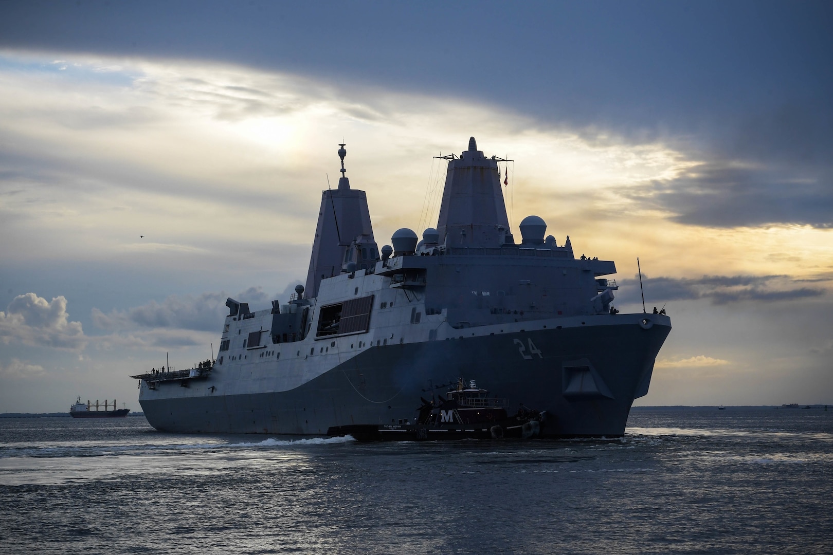 A ship moves away from a dock.