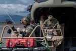 U.S. Air Force Special Tactics operators load tactical vehicles onto a U.S. Army CH-47 Chinook helicopter at Soto Cano Air Base, Honduras, Nov. 23, 2020, while prepping for a landing zone assessment and survey mission.