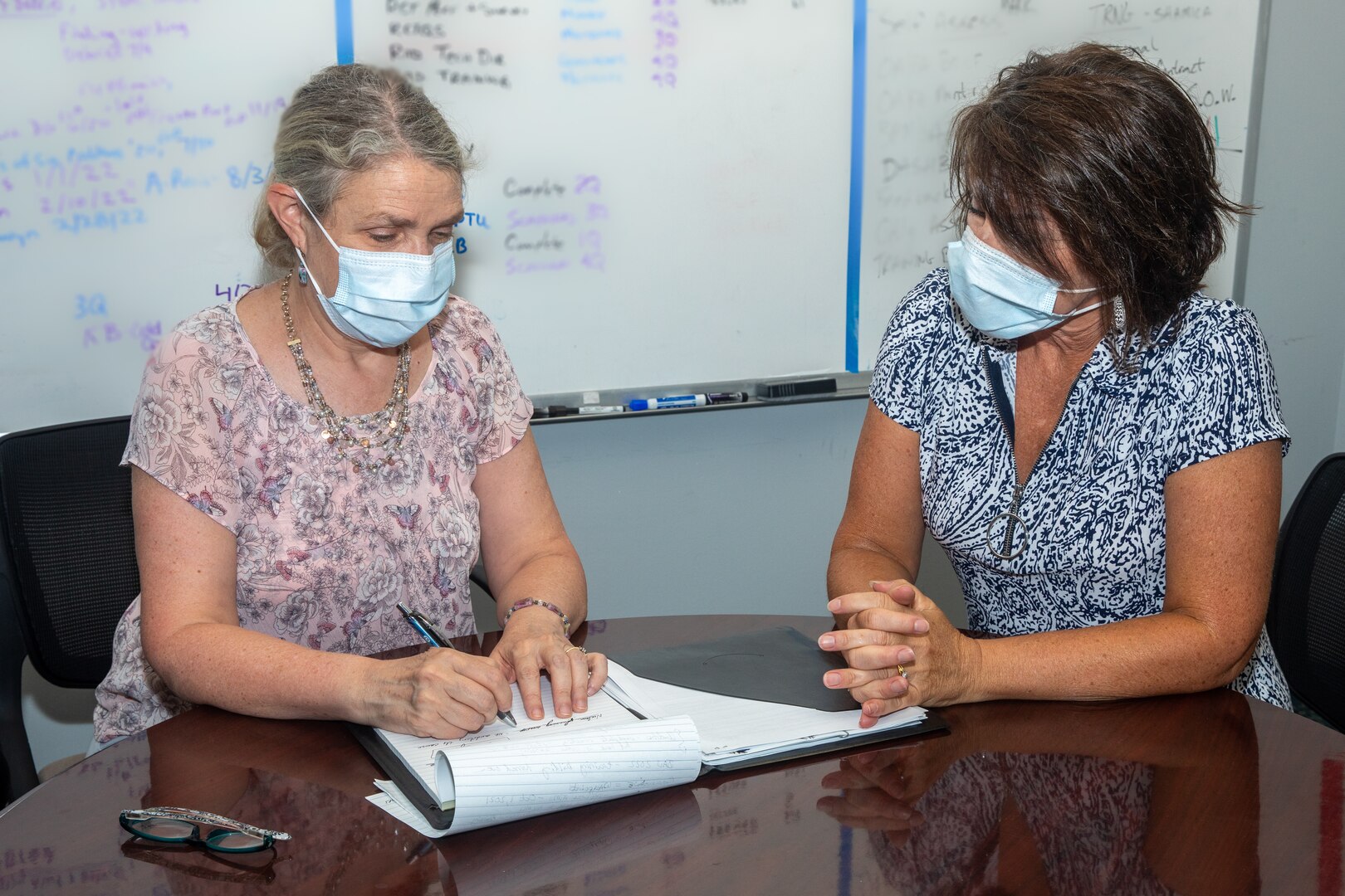 Nuclear Quality Division (Code 2350) Division Head Tina Hazard discusses assessments with Code 2350 Administrative Assistant Kim Zaner.
