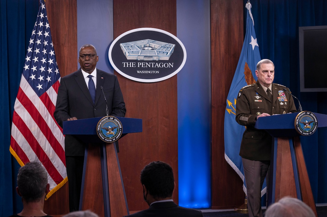 Secretary of Defense Lloyd J. Austin III and Joint Chiefs of Staff Chairman Army Gen. Mark A. Milley stand at podiums.