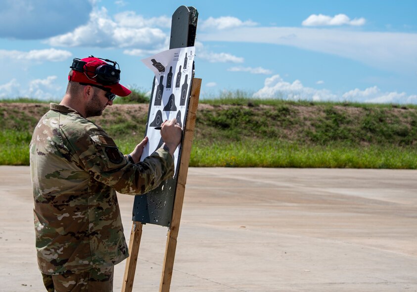 A photo of an airman on a firing range