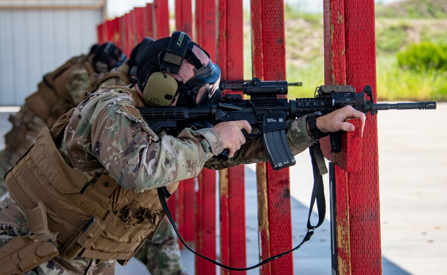 A photo of an airman firing a rifle