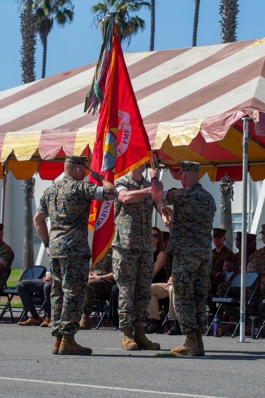 U.S. Marine Corps Lt. Col. Joseph C. Begley, outgoing commanding officer, 15th Marine Expeditionary Unit, passes the unit colors to Col. Sean P. Dynan, incoming commanding officer, 15th MEU, during a change of command ceremony at Marine Corps Base Camp Pendleton, California, July 21, 2021