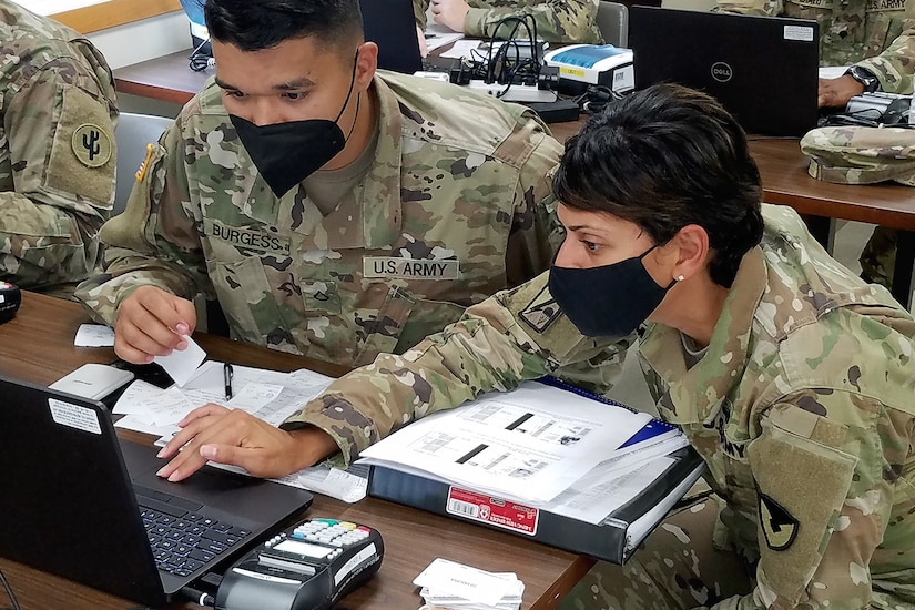 Master Sgt. Eva Miranda, U.S. Army Financial Management Command Operational Support Team senior financial management systems instructor, helps Soldiers use financial management tactical platforms, or FMTPs, during Diamond Saber at Fort McCoy, Wisconsin, Aug. 14, 2021. Diamond Saber is a U.S. Army Reserve-led exercise that incorporates participation from all components and joint services, and it prepares finance and comptroller Soldiers on the warfighting functions of funding the force, payment support, disbursing operations, accounting, fiscal stewardship, auditability and data analytics. (U.S. Army photo by Mark R. W. Orders-Woempner)