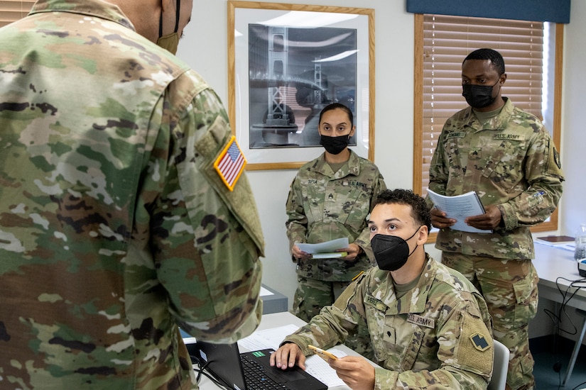 Spc. Domingo Perez-Lopez, 395th Financial Management Support Unit financial management specialist, receives simulated captured currency from 1st Lt. James Moore, 374th Financial Management Support Unit finance officer, during Diamond Saber at Fort McCoy, Wisconsin, Aug. 14, 2021. Diamond Saber is a U.S. Army Reserve-led exercise that incorporates participation from all components and joint services, and it prepares finance and comptroller Soldiers on the warfighting functions of funding the force, payment support, disbursing operations, accounting, fiscal stewardship, auditability and data analytics. (U.S. Army photo by Mark R. W. Orders-Woempner)