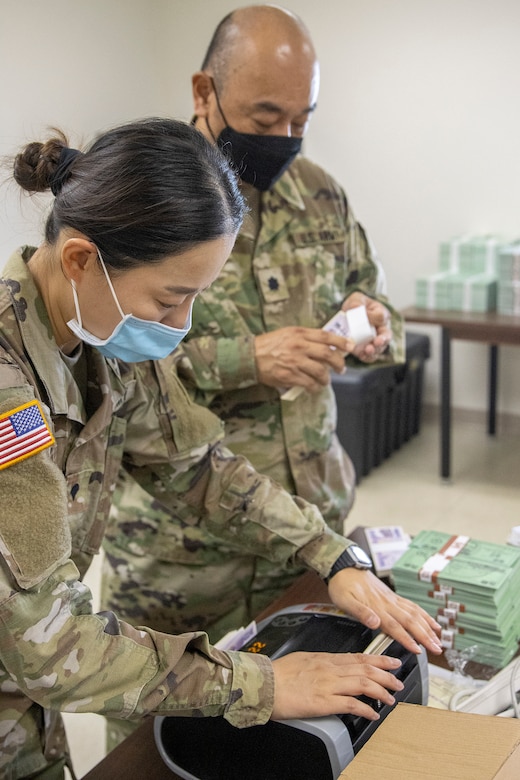 Spc. Saralin Moon, 326th Financial Management Support Center disbursing technician, and Lt. Col. Luke Ahn, 326th FMSC disbursing officer, count simulated money after moving their operation in less than two hours during Diamond Saber at Fort McCoy, Wisconsin, Aug. 14, 2021. Diamond Saber is a U.S. Army Reserve-led exercise that incorporates participation from all components and joint services, and it prepares finance and comptroller Soldiers on the warfighting functions of funding the force, payment support, disbursing operations, accounting, fiscal stewardship, auditability and data analytics. (U.S. Army photo by Mark R. W. Orders-Woempner)