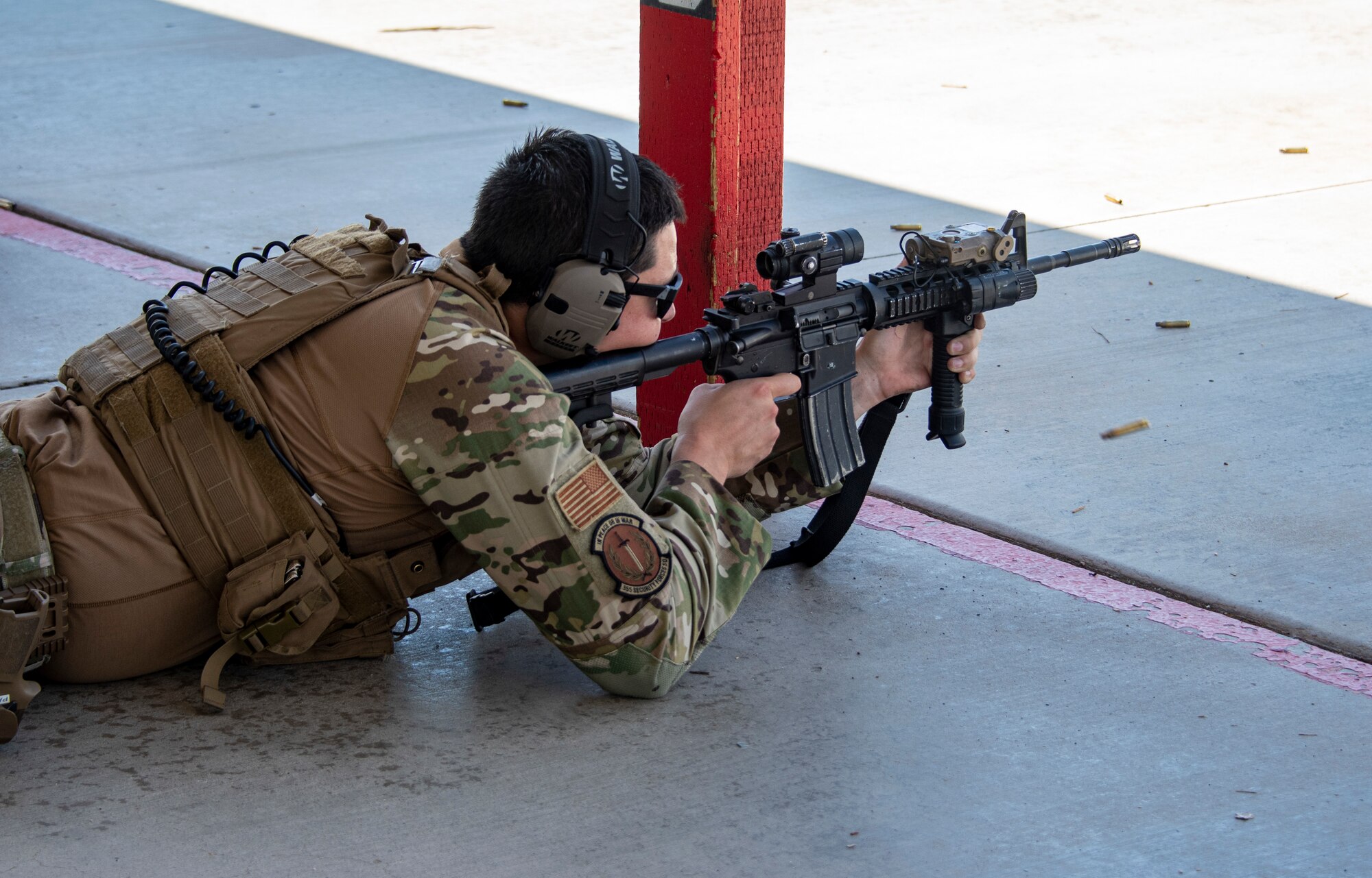 A photo of an airmen firing an rifle