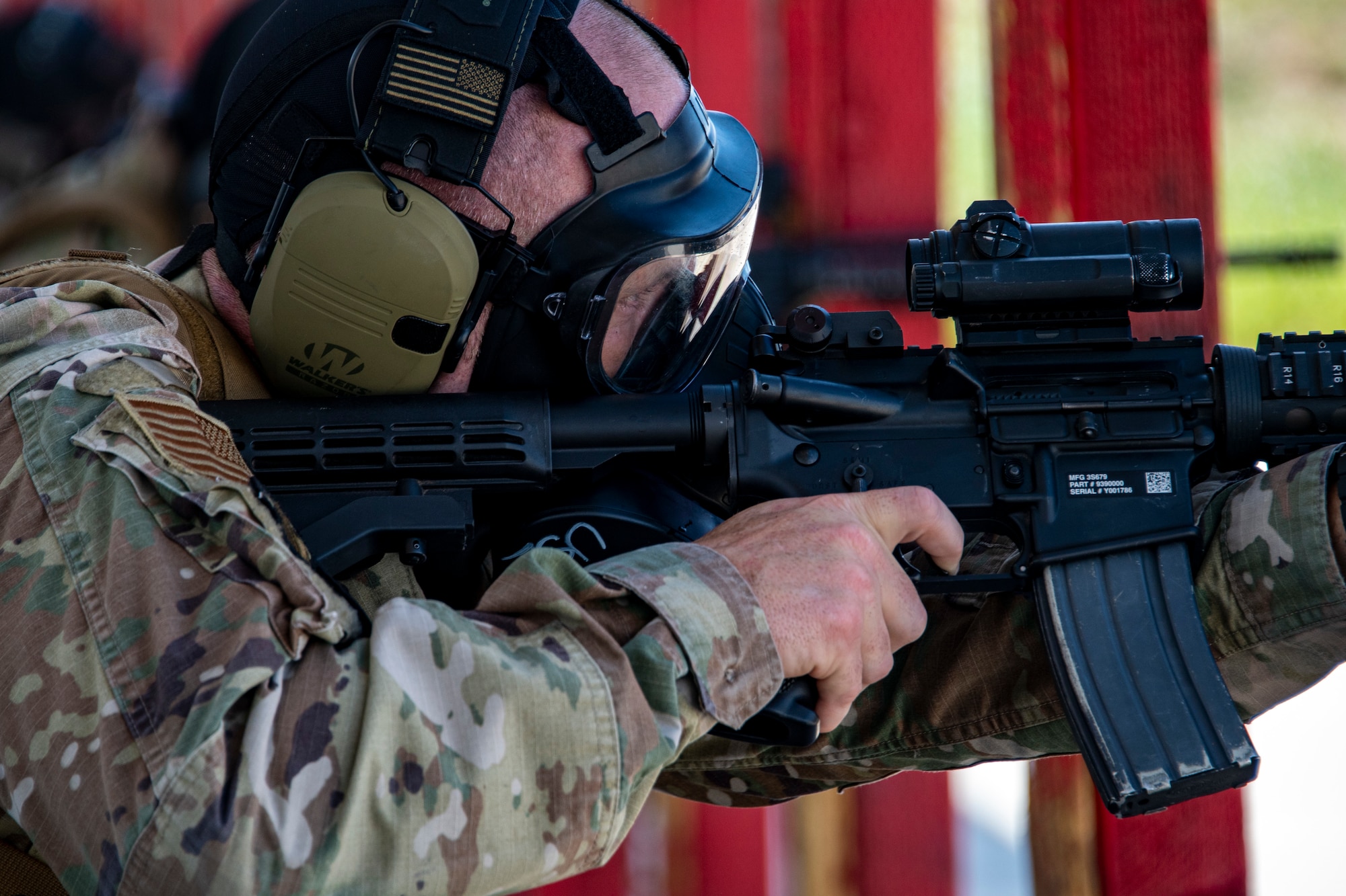 A photo of an airman firing a rifle