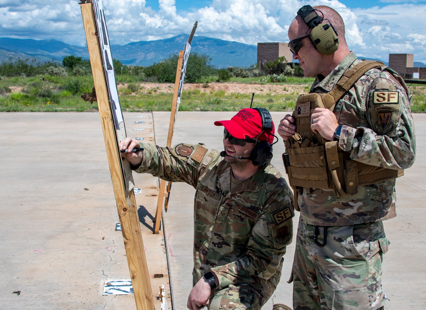 A photo of two airmen on a firing range