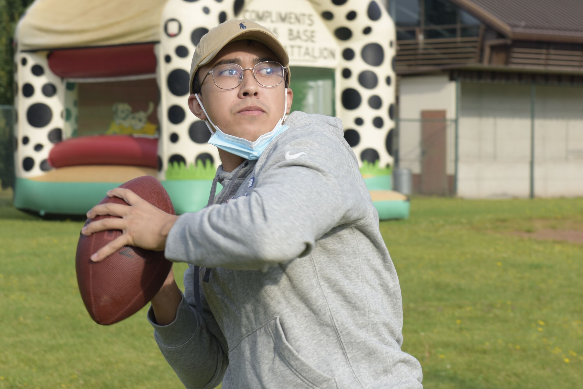 U.S. Air Force Senior Airman Ryan Padin throws a football