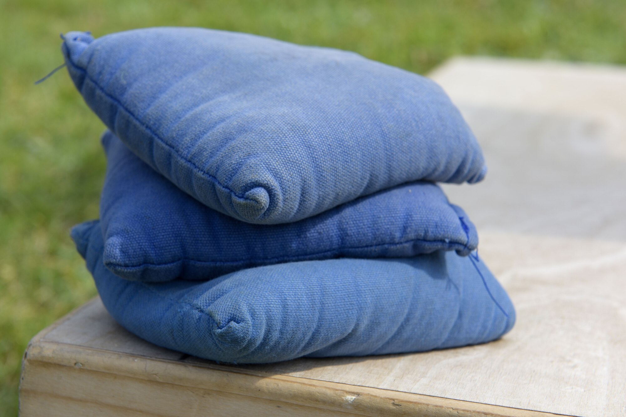 Bean bags rest on a cornhole board