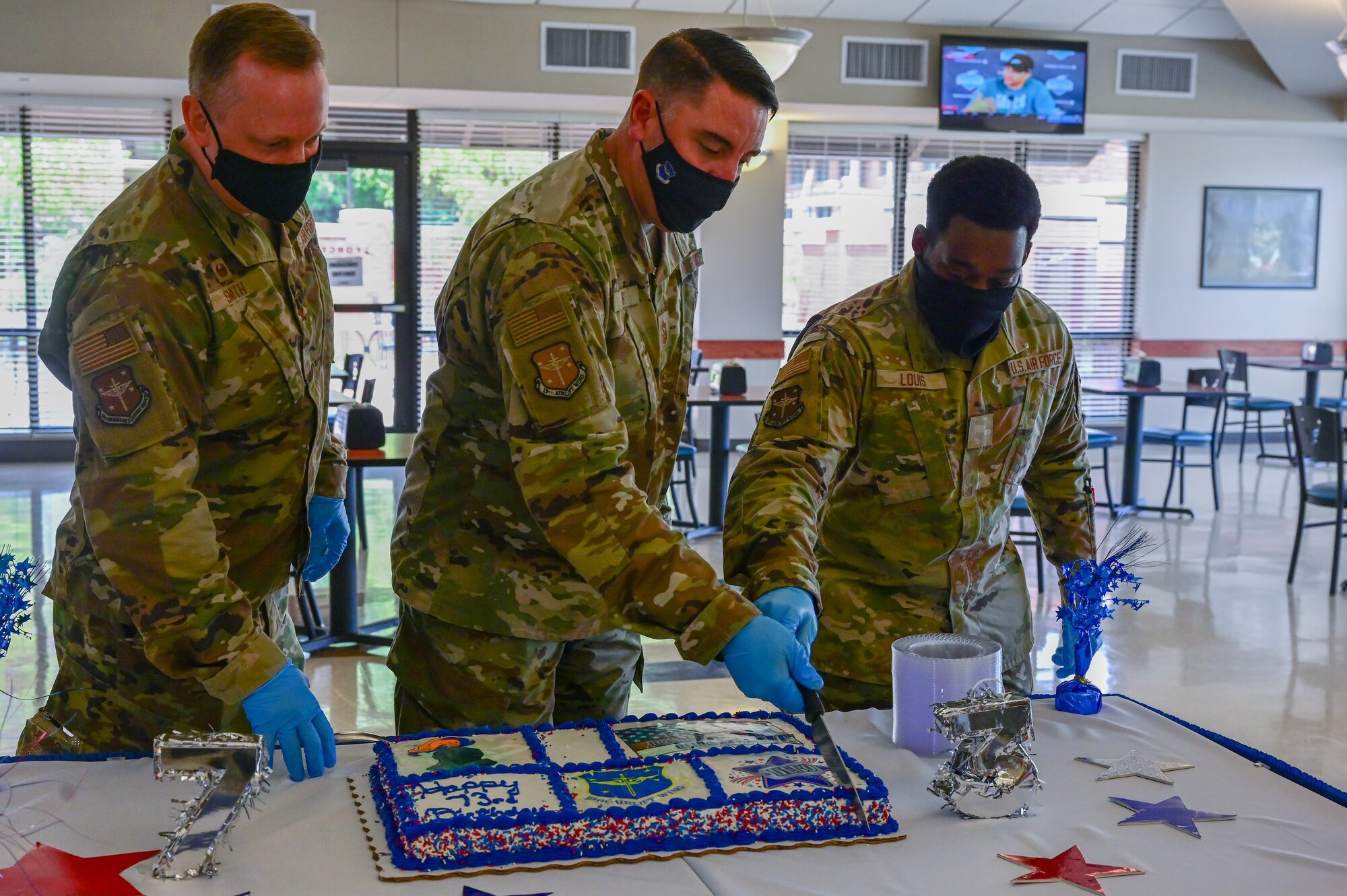 Col. Bernard Smith, 19th Mission Support Group commander, Chief Master Sgt. Steven Hart, 19th Airlift Wing command chief, and Airman Eason Louis, 19th Airlift Wing religious affairs Airman, cut a cake in celebration of the 19th Airlift Wing’s 73rd birthday