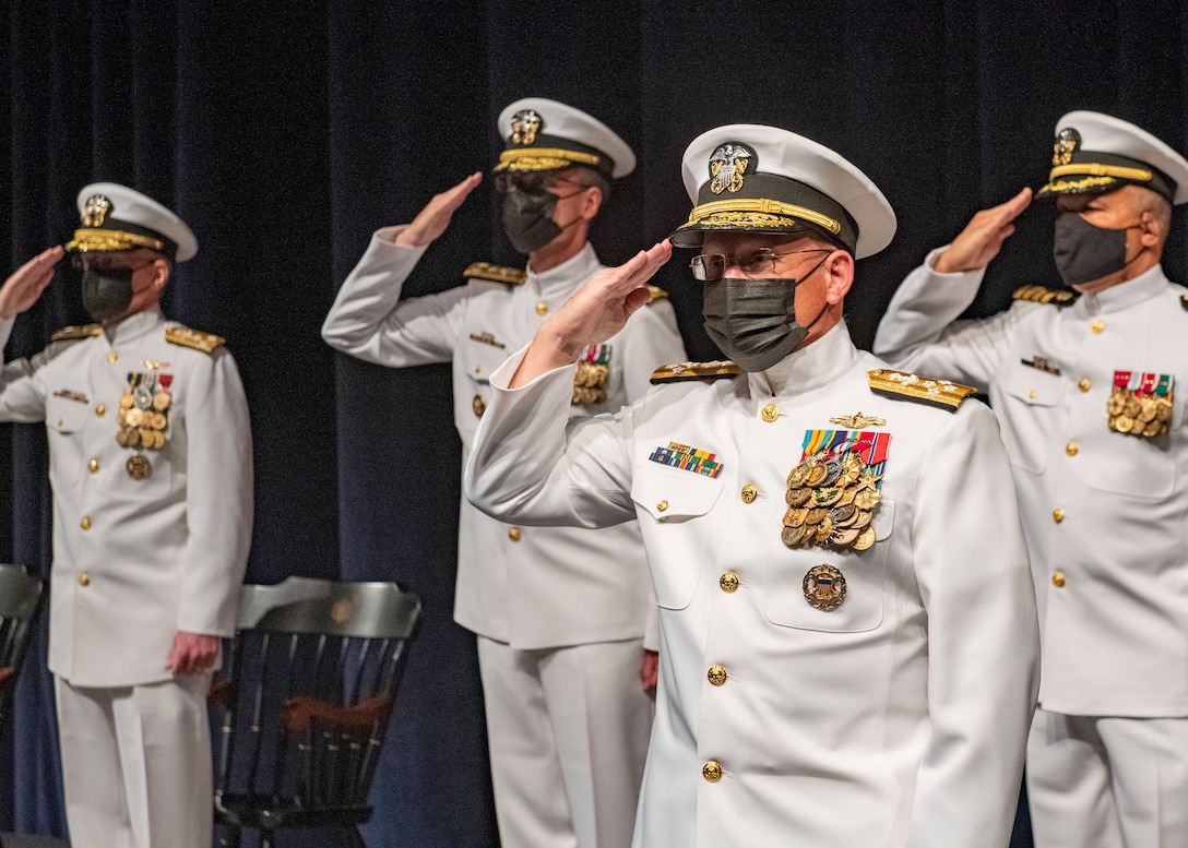 Chief of Naval Operations Adm. Mike Gilday salutes the colors while presiding over a change of office ceremony at the U.S. Naval Academy in which Vice Adm. John G. Hannink was relieved by Vice Adm. Darse “Del” E. Crandall.