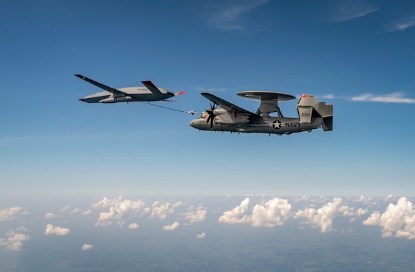 An MQ-25 Stingray unmanned aerial vehicle refuels an E-2D Advanced Hawkeye aircraft over MidAmerica Airport in Mascoutah, Ill.