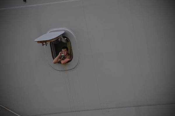 NAVAL STATION NORFOLK (Aug. 17, 2021) A Sailor stands watch aboard the amphibious transport dock ship USS Arlington (LPD 24) as the ship prepares to depart Naval Station Norfolk.  Arlington will support humanitarian assistance and disaster relief (HADR) efforts in Haiti following a 7.2-magnitude earthquake on Aug. 14, 2021. (U.S. Navy photo by Mass Communication Specialist 1st Class Jacob Milham)