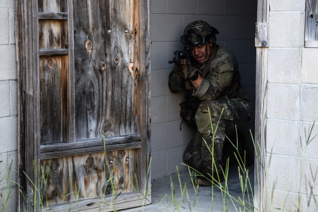 U.S. Army National Guard and Reserve Soldiers conduct urban operations training July 27, 2021, during the 11B Infantry Transition Course, taught by the 183rd Regiment, Regional Training Institute at Fort Pickett, Virginia. This training event served as the culminating event for the 25 Soldiers enrolled in the course, who will earn the 11B Infantryman military occupational speciality after successful completion of three weeks of hands-on infantry training. (U.S. Army National Guard photo by Sgt. 1st Class Terra C. Gatti)