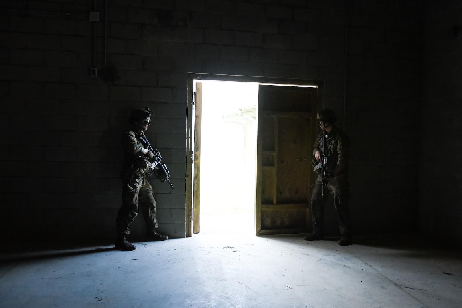 U.S. Army National Guard and Reserve Soldiers conduct urban operations training July 27, 2021, during the 11B Infantry Transition Course, taught by the 183rd Regiment, Regional Training Institute at Fort Pickett, Virginia. This training event served as the culminating event for the 25 Soldiers enrolled in the course, who will earn the 11B Infantryman military occupational speciality after successful completion of three weeks of hands-on infantry training. (U.S. Army National Guard photo by Sgt. 1st Class Terra C. Gatti)