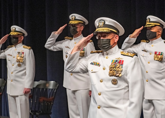 Chief of Naval Operations Adm. Mike Gilday salutes the colors while presiding over a change of office ceremony at the U.S. Naval Academy in which Vice Adm. John G. Hannink was relieved by Vice Adm. Darse “Del” E. Crandall.
