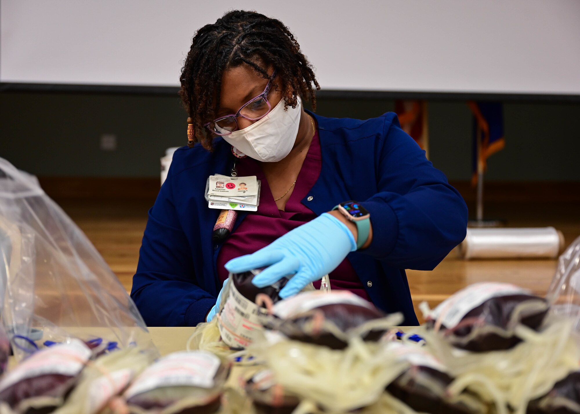 A phlebotomist labels donated blood during a blood drive